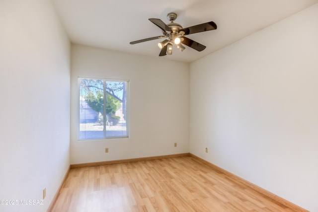 unfurnished room featuring light wood-type flooring, baseboards, and a ceiling fan