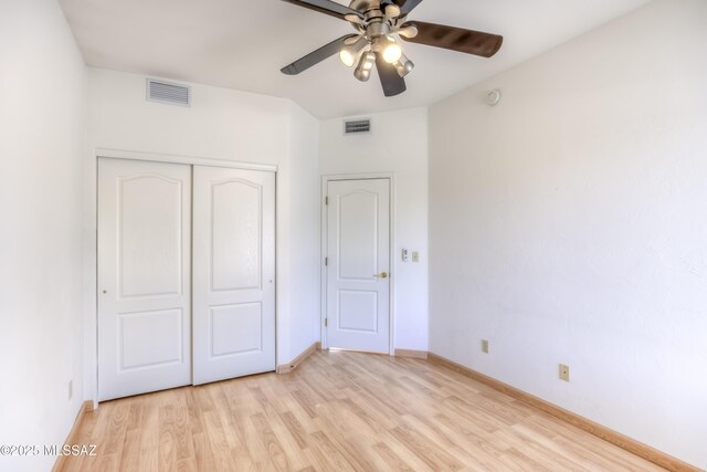 unfurnished bedroom featuring a closet, visible vents, baseboards, and light wood-style floors