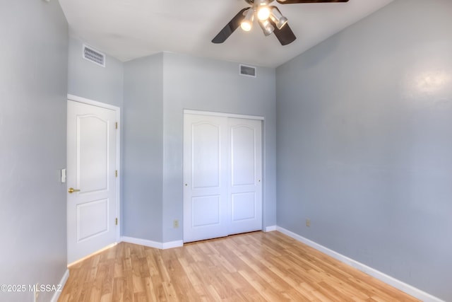 unfurnished bedroom with visible vents, baseboards, a closet, and light wood finished floors