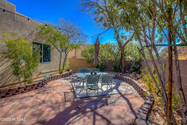 view of patio / terrace featuring outdoor dining space and a fenced backyard