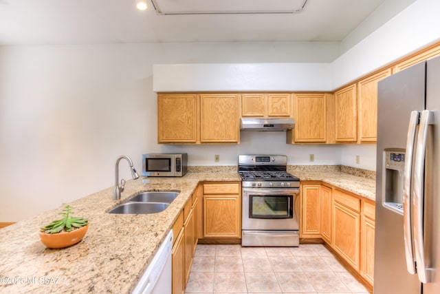 kitchen with light stone counters, light tile patterned floors, a sink, stainless steel appliances, and under cabinet range hood