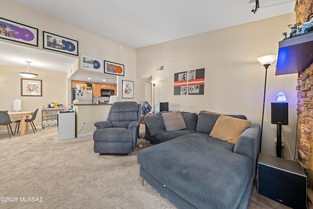 101 S Players Club Dr Unit 11202, Tucson, AZ 85745 - living area featuring a high ceiling, carpet, visible vents, and baseboards