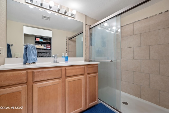 101 S Players Club Dr Unit 11202, Tucson, AZ 85745 - bathroom with vanity, a shower stall, and visible vents