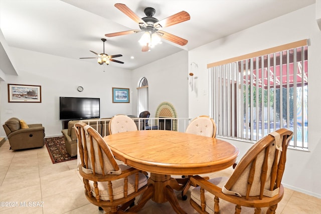 dining room with light tile patterned floors, baseboards, and a ceiling fan