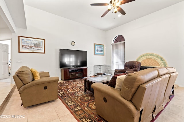 living area featuring light tile patterned floors and ceiling fan