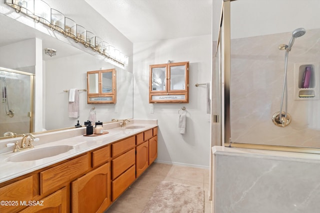 full bathroom with a sink, a stall shower, double vanity, and tile patterned flooring