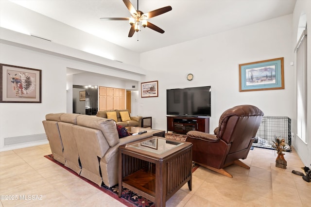 living room featuring light tile patterned flooring, visible vents, and ceiling fan