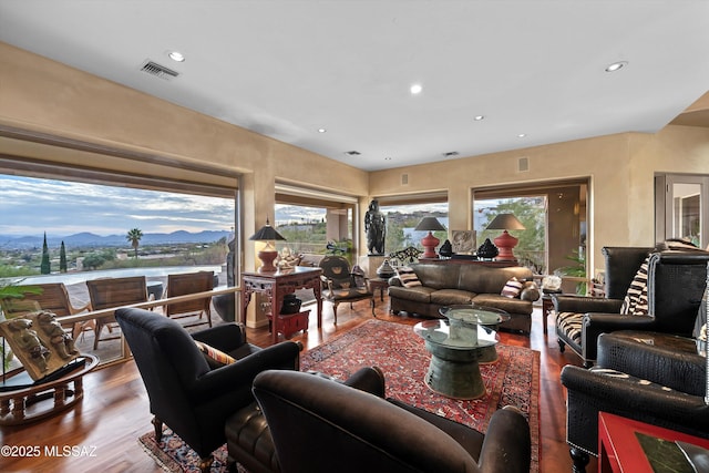 living area with visible vents, a mountain view, wood finished floors, and recessed lighting