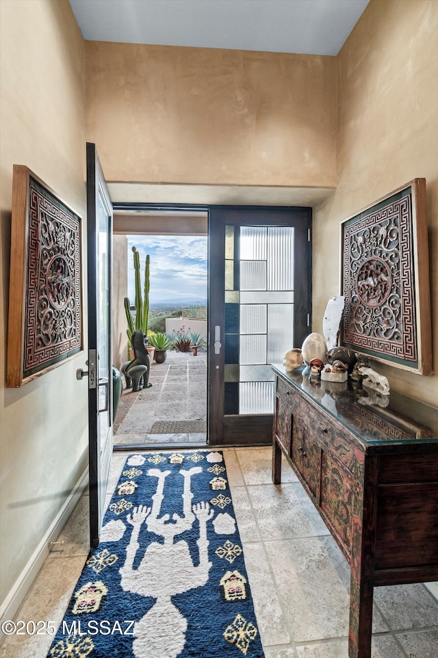 entrance foyer featuring french doors and baseboards