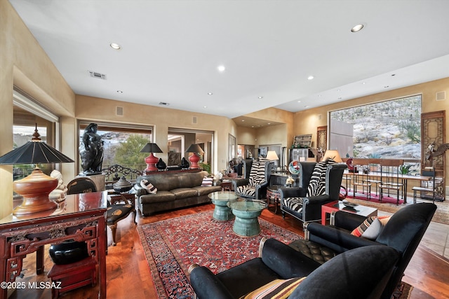 living room featuring visible vents, a wealth of natural light, and recessed lighting