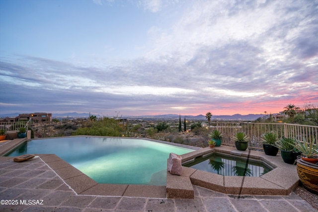 view of pool featuring a pool with connected hot tub and a patio area