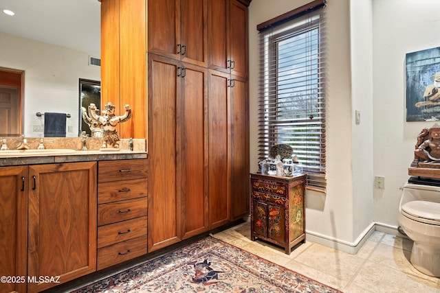 bathroom with visible vents, baseboards, toilet, tile patterned floors, and vanity