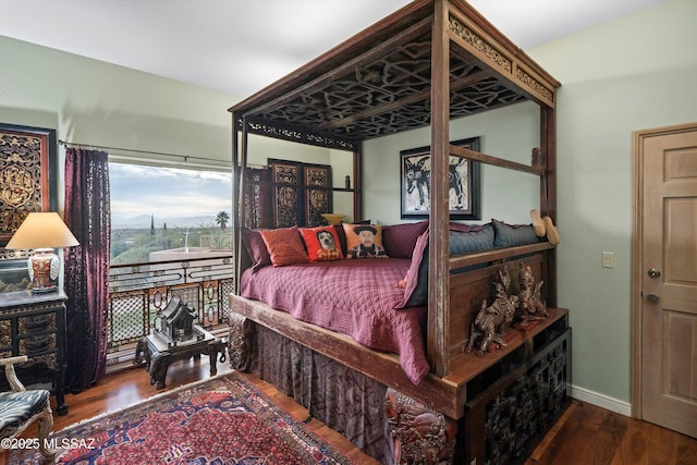 bedroom with wood finished floors and baseboards