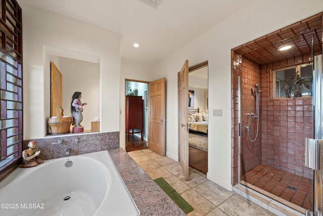 ensuite bathroom with baseboards, ensuite bath, a garden tub, a shower stall, and recessed lighting