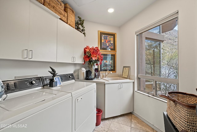 laundry room with cabinet space, baseboards, washing machine and clothes dryer, a sink, and recessed lighting