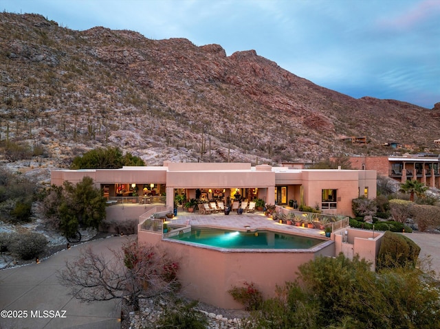 outdoor pool with a patio area and a mountain view