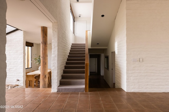 stairs featuring tile patterned flooring