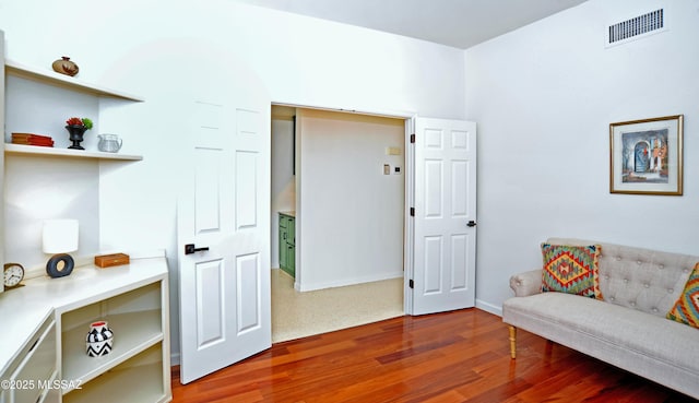 sitting room with visible vents and wood finished floors