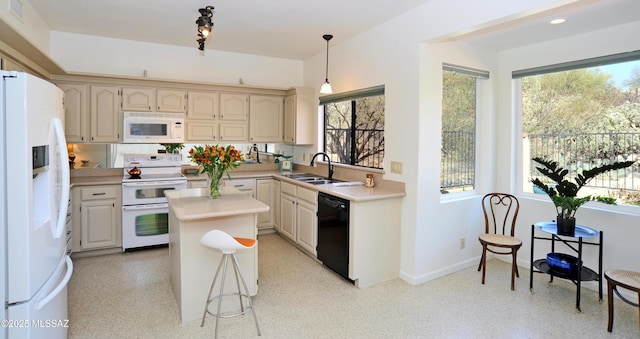 kitchen with light countertops, hanging light fixtures, a kitchen island, a sink, and white appliances