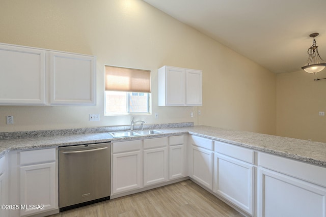 kitchen featuring white cabinets, dishwasher, vaulted ceiling, light wood-type flooring, and a sink