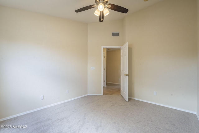 unfurnished bedroom featuring baseboards, visible vents, ceiling fan, and carpet flooring