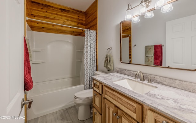 bathroom with shower / bath combo, vanity, and toilet