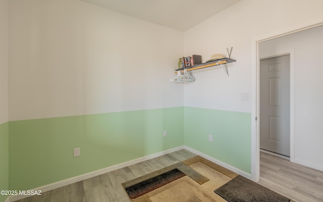 empty room featuring baseboards and wood finished floors