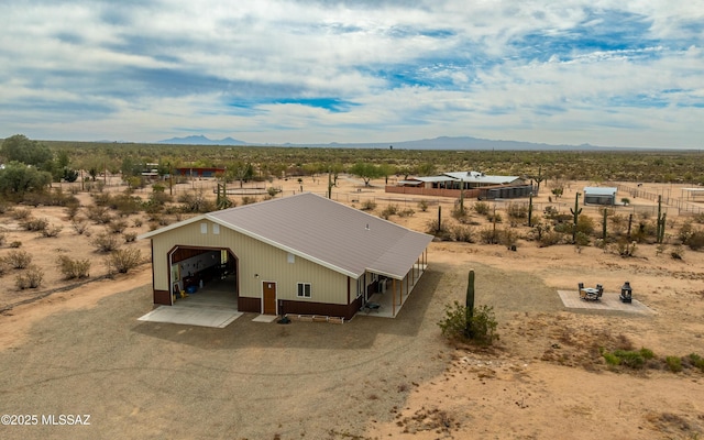 bird's eye view featuring a mountain view and view of desert