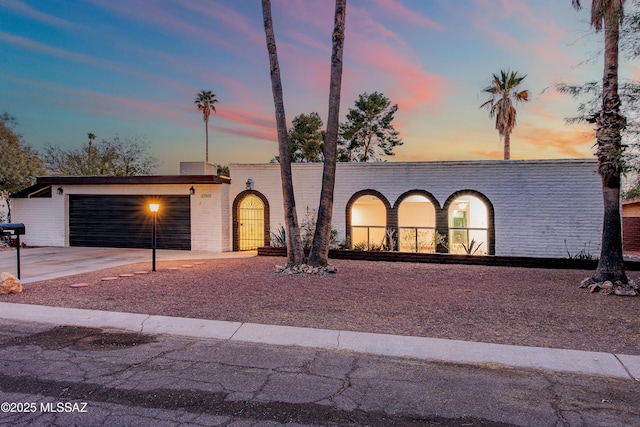 view of front of house with a garage and concrete driveway