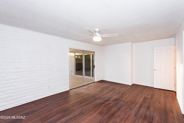 empty room featuring a textured ceiling, wood finished floors, a ceiling fan, and baseboards