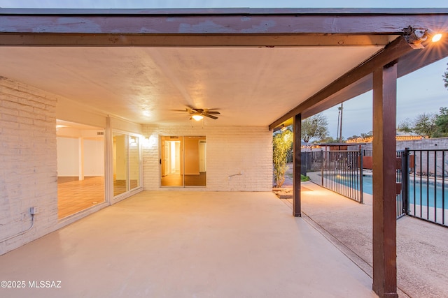 view of patio with fence, a ceiling fan, and a fenced in pool