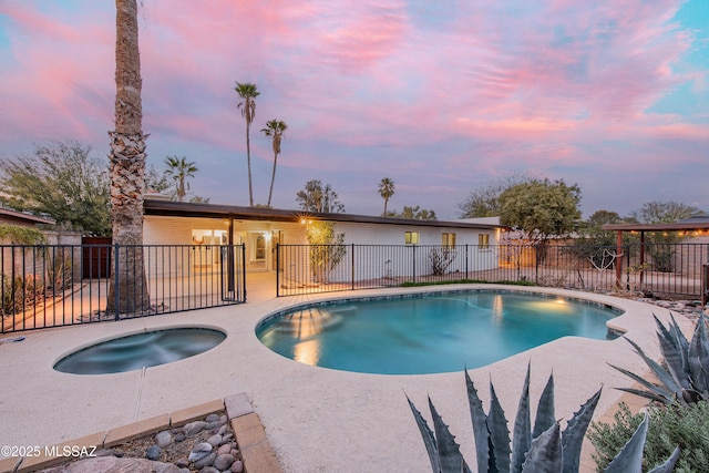 view of swimming pool featuring a patio area, fence, and a fenced in pool