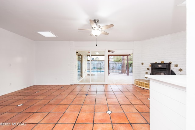 spare room with light tile patterned floors and a ceiling fan