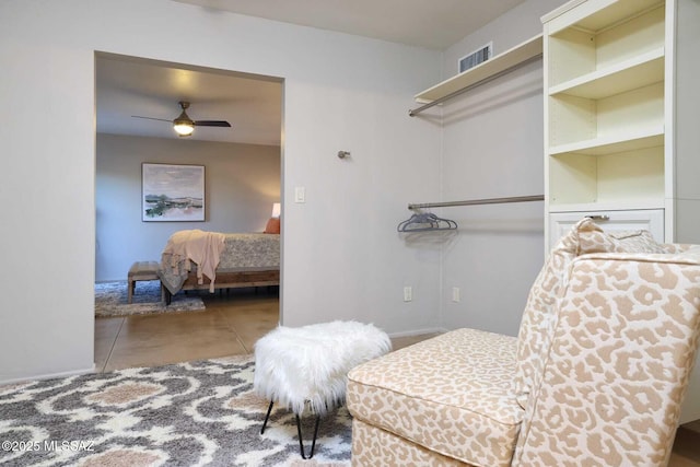 interior space featuring visible vents and a ceiling fan