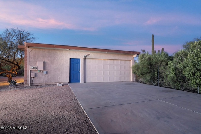 garage with concrete driveway