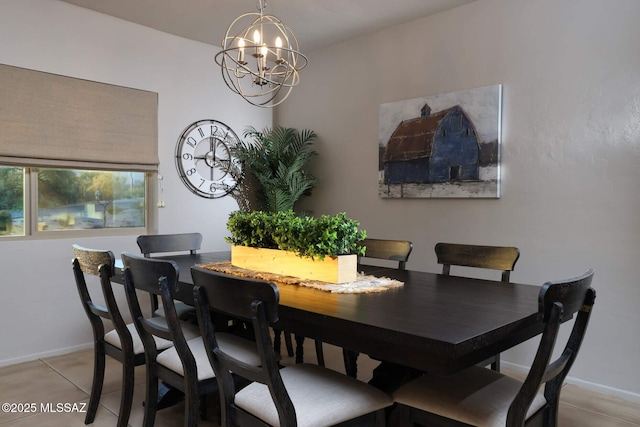 dining room with a chandelier, light tile patterned floors, and baseboards