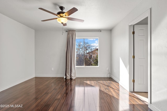 unfurnished room with wood finished floors, baseboards, and ceiling fan