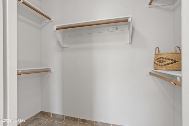 spacious closet with tile patterned floors