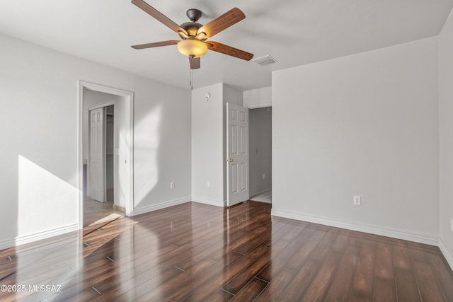 unfurnished bedroom featuring visible vents, baseboards, a ceiling fan, and wood finished floors