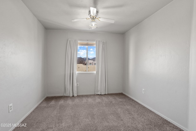 unfurnished room featuring ceiling fan, baseboards, and carpet flooring