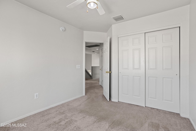 unfurnished bedroom with visible vents, baseboards, ceiling fan, carpet flooring, and a closet