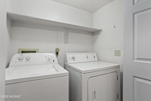 clothes washing area featuring independent washer and dryer and laundry area