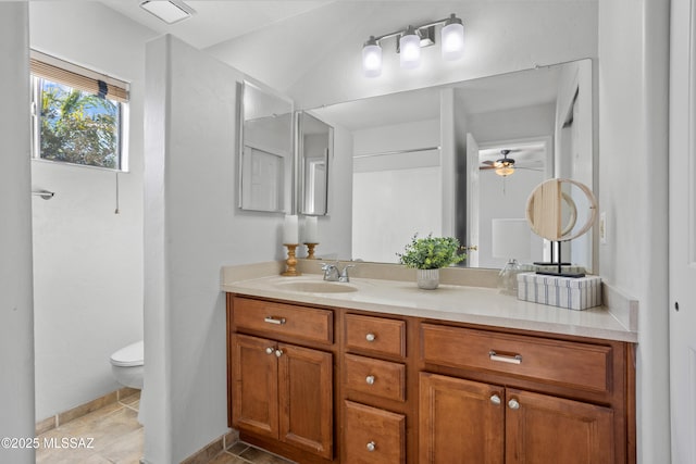 bathroom featuring ceiling fan, vanity, tile patterned flooring, toilet, and baseboards