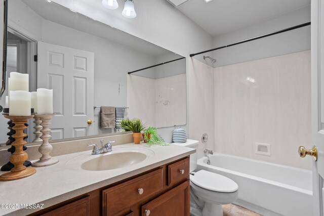 bathroom with shower / bath combination, vanity, and toilet