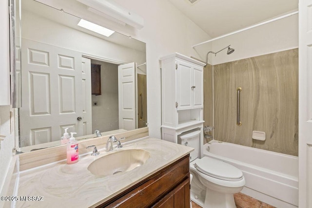 bathroom with toilet, a skylight, vanity, and shower / bathing tub combination