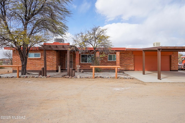 view of front of house featuring brick siding and central AC unit