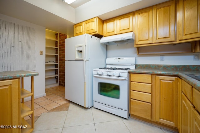 kitchen featuring dark countertops, white appliances, under cabinet range hood, and light tile patterned floors