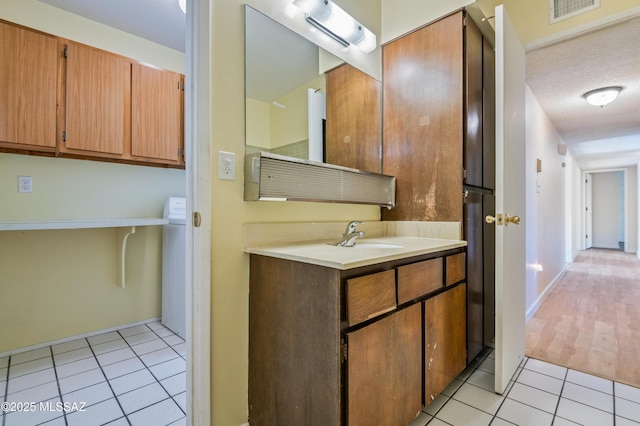 bathroom featuring vanity, visible vents, and tile patterned floors