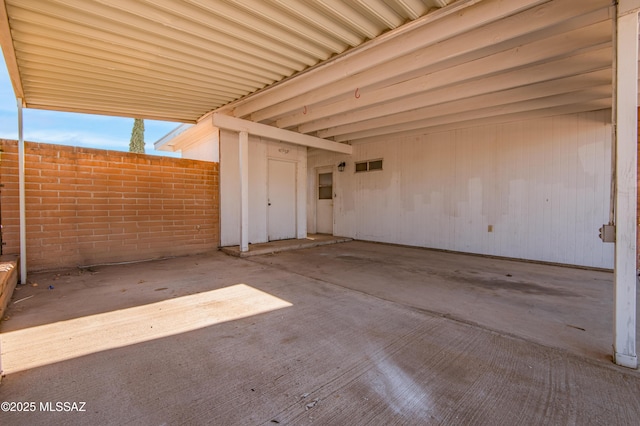 view of patio / terrace featuring a carport and fence