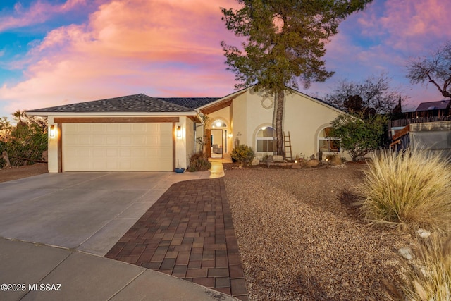 10117 E Sky Castle Way, Tucson, AZ 85730 - view of front facade with driveway, stucco siding, and an attached garage